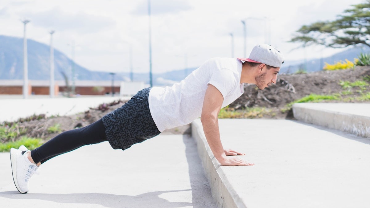 Young man doing different types of exercises in the park.